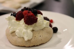 Chocolate meringues with whipped cream and fresh berries