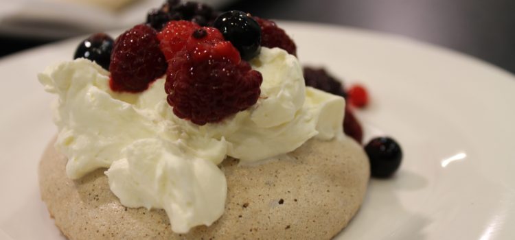 Chocolate meringues with whipped cream and fresh berries